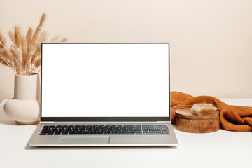 laptop mockup on the table with ceramic vase, lagurus grass bouquet, wooden box and brown linen clot