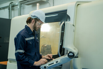Fototapete - Engineer operating CNC computer machine working in industry factory.