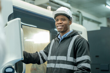 Aufkleber - Engineer using laptop for programming modern robot arm in automated manufacturing industry,Factory worker with responsibility for programming industrial machine to control the process of production.