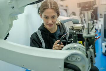 Aufkleber - Technical engineer working with adept robotic arm in a workshop,Industrial robot programming software for automated manufacturing technology .