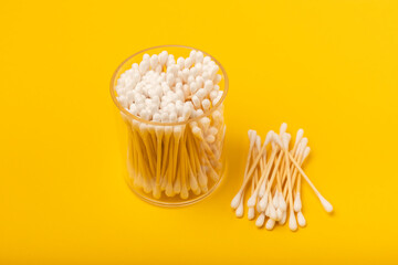 Cotton swabs on a yellow texture background. Bamboo cotton buds. Means for hygiene of ears. Eco-friendly materials.Hygienic cotton ear buds.