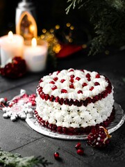 Sticker - Vertical shot of a gourmet homemade cake with white frosting and pomegranate seeds