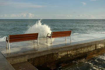 Wall Mural - Waves flow over the promenade.