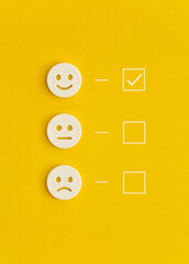 Emoticon smile on a yellow background. Customer feedback.