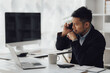 © Kritdanai - Happy working asian businessman talking on the phone with accounting documents at desk in happy working office
