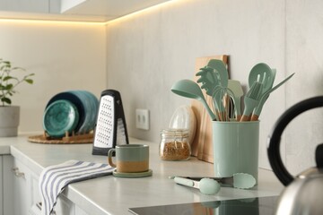 Wall Mural - Set of different utensils and dishes on countertop in kitchen