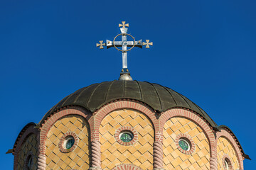 Large religious cross on top of the dome of an orthodox church