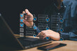 © NongAsimo - Electronic smart checklist and document management on virtual screens concept, Businessman using laptop marking online checklist document and customer satisfaction survey