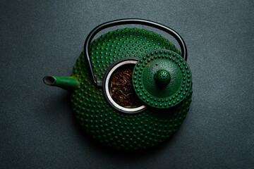 Wall Mural - Traditional Japanese teapot for brewing tea. On a black stone background. Top view. Free space for text.