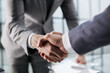 © Katsiaryna - Handshake of two businessmen who enters into the contract to develop a new software to improve business service at a company.
