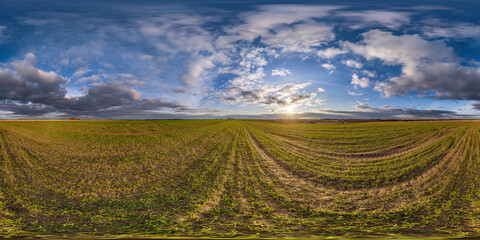 Wall Mural - 360 hdri panorama view among fields with sunset sky in golden hour in countryside in equirectangular