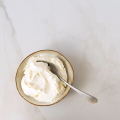 Wall Mural - a bowl of mascarpone cheese on a light marble table