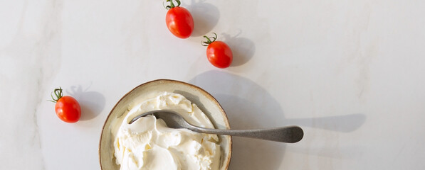 Wall Mural - bowl with mascarpone and cherry tomatoes on light table