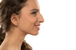 Profile portrait of a beautiful smiling young woman, a nose with a hump on white background