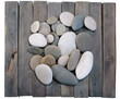Few big colorful rounded pebbles on wooden planks view from above on white background