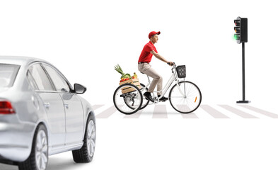 Wall Mural - Guy riding a tricycle with a crate of fruits and vegetables at a pedestrian crossing