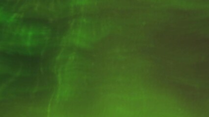 Wall Mural - Green background with magic dust. Motion. Small illuminated particles flying in different directions in abstraction.
