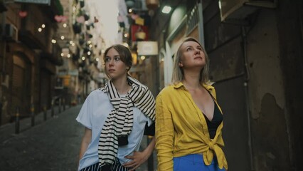 Wall Mural - Two female tourists exploring the old town.