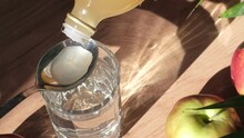 Woman Preparing A Natural Home Remedy By Mixing Apple Cider Vinegar With Water To Help Alleviate Various Health Concerns. Top Natural Remedies.