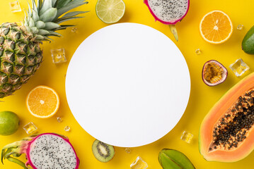 Wall Mural - A sip of paradise. Top flat lay view photo of dragon-fruit, kiwi, papaya, pineapple, orange, lime, passion fruit, avocado on yellow background with empty circle for text