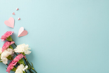 Wall Mural - Mother's Day gift idea concept. Top view flat lay photo of carnation flowers, and pink paper hearts on pastel blue background with empty space for text or advert