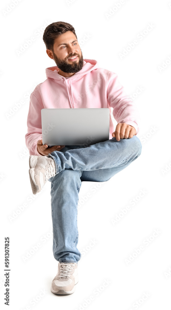 Handsome bearded man with laptop sitting in chair on white background