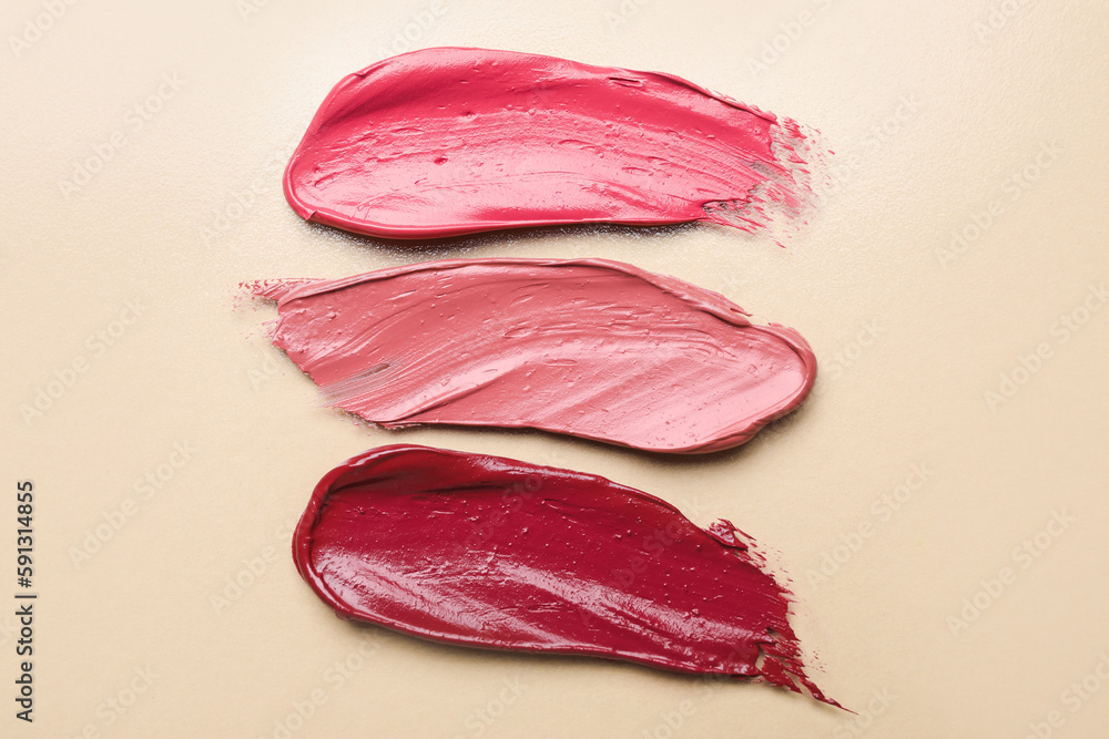 Lipstick strokes on beige background