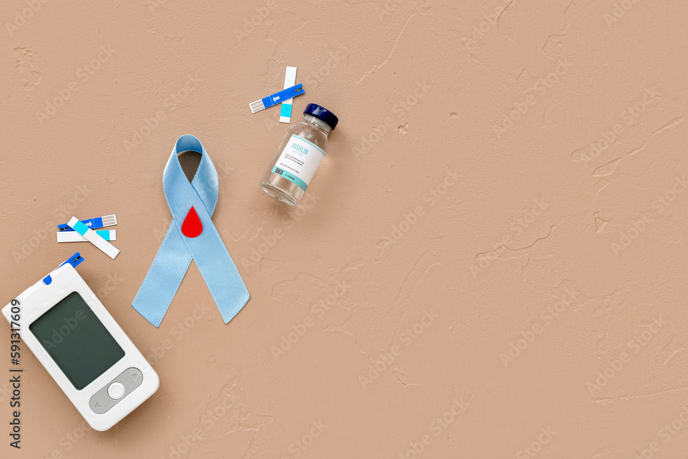 Awareness ribbon with glucometer and insulin on beige background. Diabetes concept