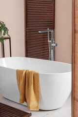 Wall Mural - Stylish bathroom interior with ceramic tub and terry towel