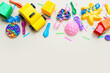 © Pixel-Shot - Baby toys with confetti and balloons on beige background. Children's Day celebration