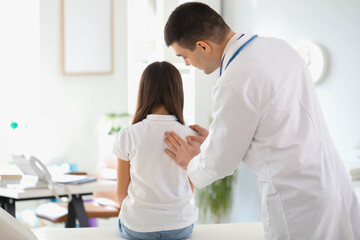 Poster - Doctor checking posture of little girl in clinic