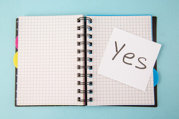 Wall Mural - top view open copybook with yes note on blue background color notepad school lessons study student c