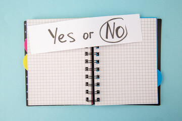 Wall Mural - top view open copybook with yes or no note on blue background color notepad school lessons study stu
