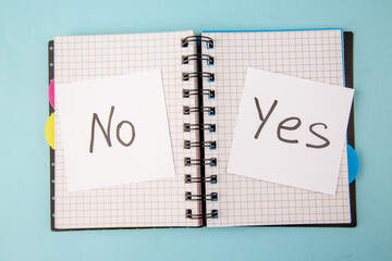 Wall Mural - top view open copybook with yes or no note on blue background color notepad school study student col