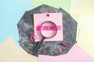 Wall Mural - top view plan written note with magnifier on gray background student paper college lesson notepad pe