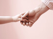 father holding the hand of his little daughter on pink background, family concept. AI generative image.