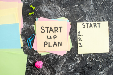 Wall Mural - top view start up plan note on sticker on gray background lesson student note school paper sticker n