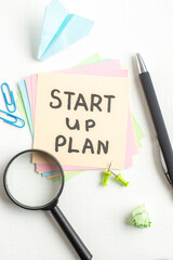 Wall Mural - top view start up plan note on sticker with pen and magnifier on gray background lesson student note
