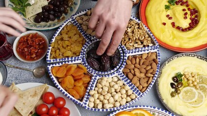 Wall Mural - Muslim Family Breaking Fast with Dates During Ramadan