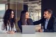 © FS-Stock - Business team collaborating on project together, using laptops. Business colleagues in casual working together in contemporary office space.