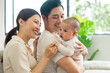 © 1112000 - Smiling mother and father holding newborn son at home