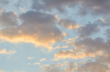 Wall Mural - blue sky background with golden clouds at sunset