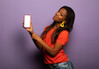 Portrait of positive young afro american woman promoter show smartphone