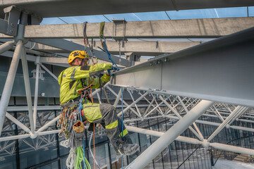 Rope access technicians assemble metal structure