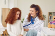 © Studio Romantic - Friendly doctor examining an adorable little child. Smiling pediatrician puts a stethoscope to her patient's back. Happy pretty ginger girl getting a medical lung checkup at a modern pediatric office