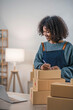 © wichayada - Startup small business entrepreneur SME, asian woman packing cloth in box. Portrait young Asian small business owner home office, online sell marketing delivery, SME e-commerce telemarketing concept.