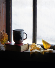 Wall Mural - Coffee mug and book on windowsill