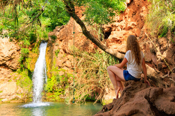 Wall Mural - Woman enjoying tropical waterfall in Algarve- Tourism in Portugal