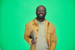 © pressmaster - Portrait of African American man in eyeglasses with digital tablet smiling at camera on green background