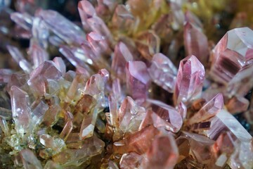 Macro shot of raw lithium quartz mineral isolated on a dark background